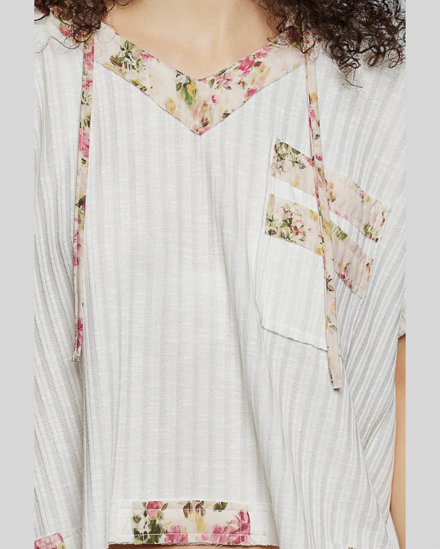 White dress with floral accents on a plain background