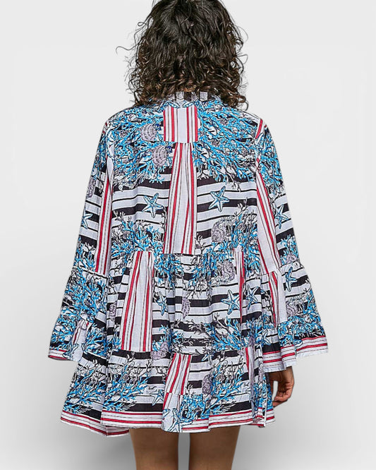 Woman wearing a colorful patterned dress on a white background