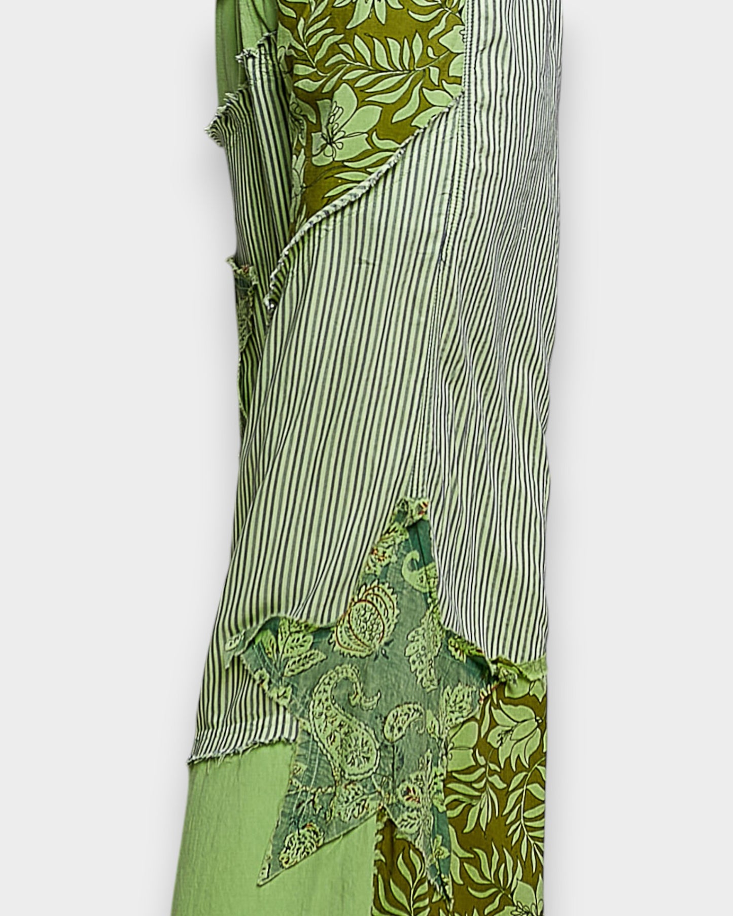 Green fabric with various patterns on a white background