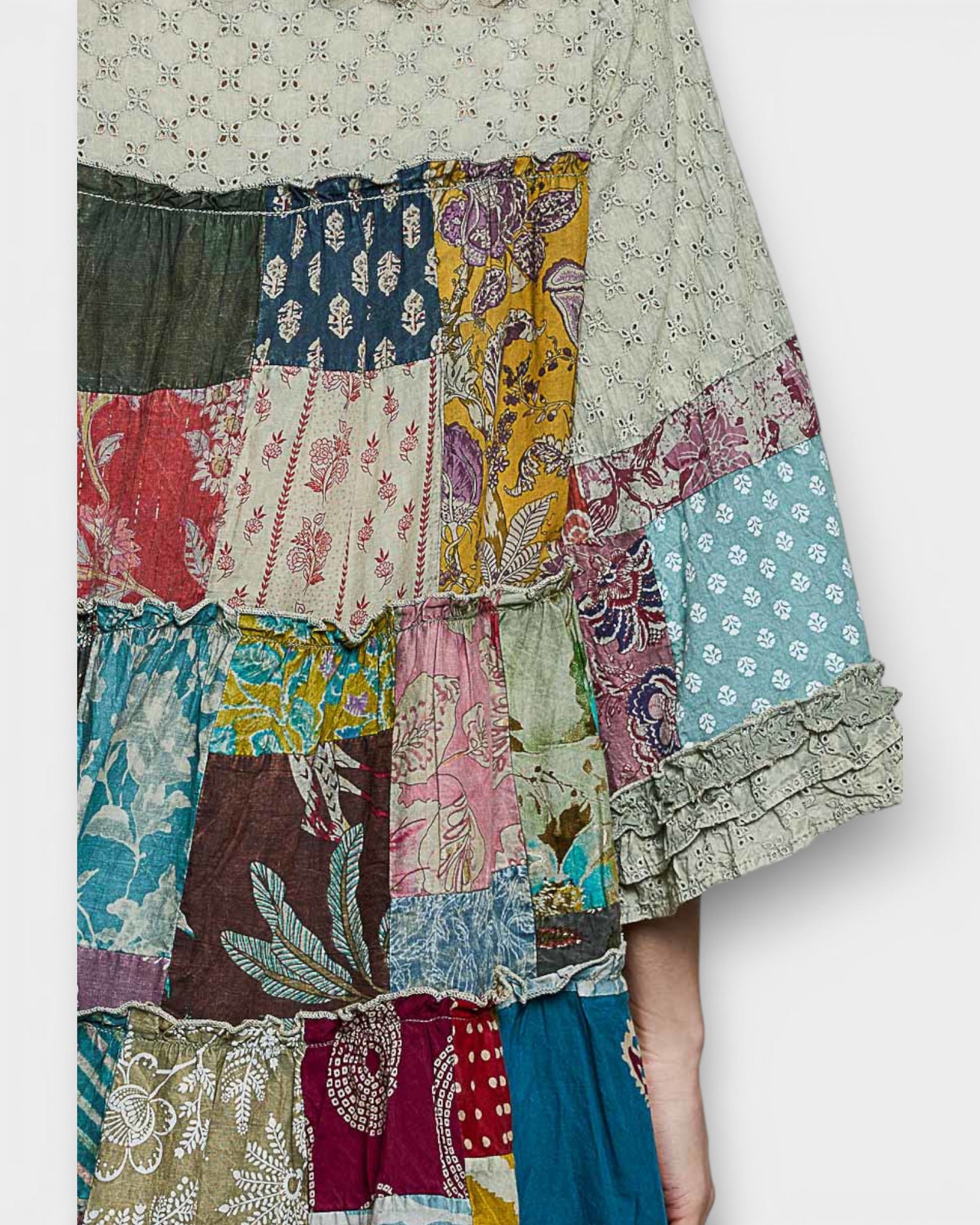 Colorful patchwork skirt with floral and abstract patterns on a white background