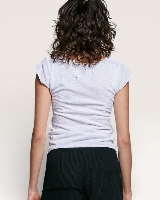 Person wearing a light gray t-shirt with a plain background