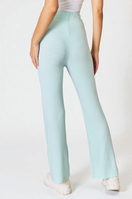 Light blue pants worn by a person on a white background