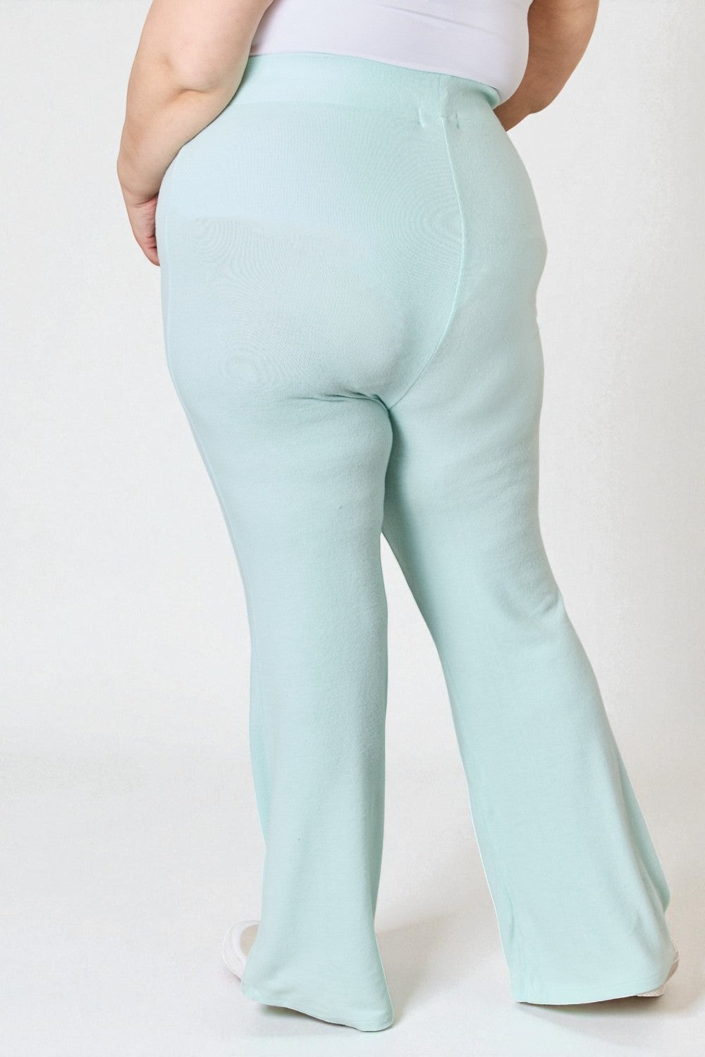 Light blue pants worn by a person on a white background