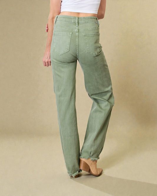 Person wearing green pants on a beige background