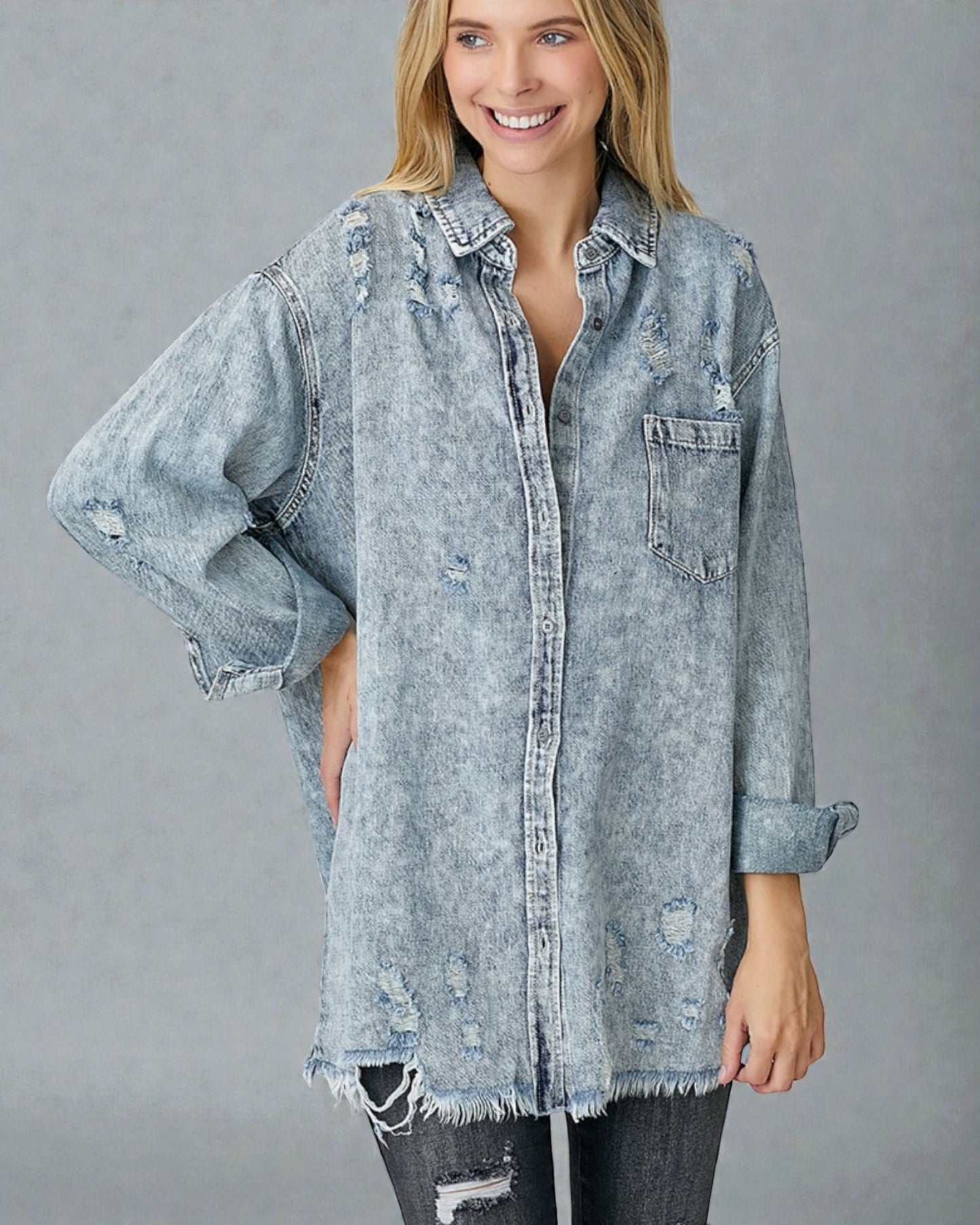 Woman wearing a light blue denim shirt with a gray background