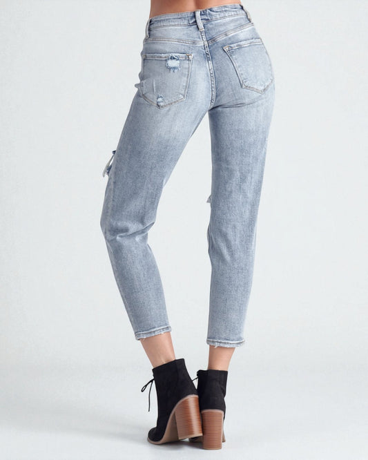 Light blue jeans worn by a person on a white background