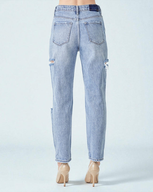 Light blue distressed jeans on a white background