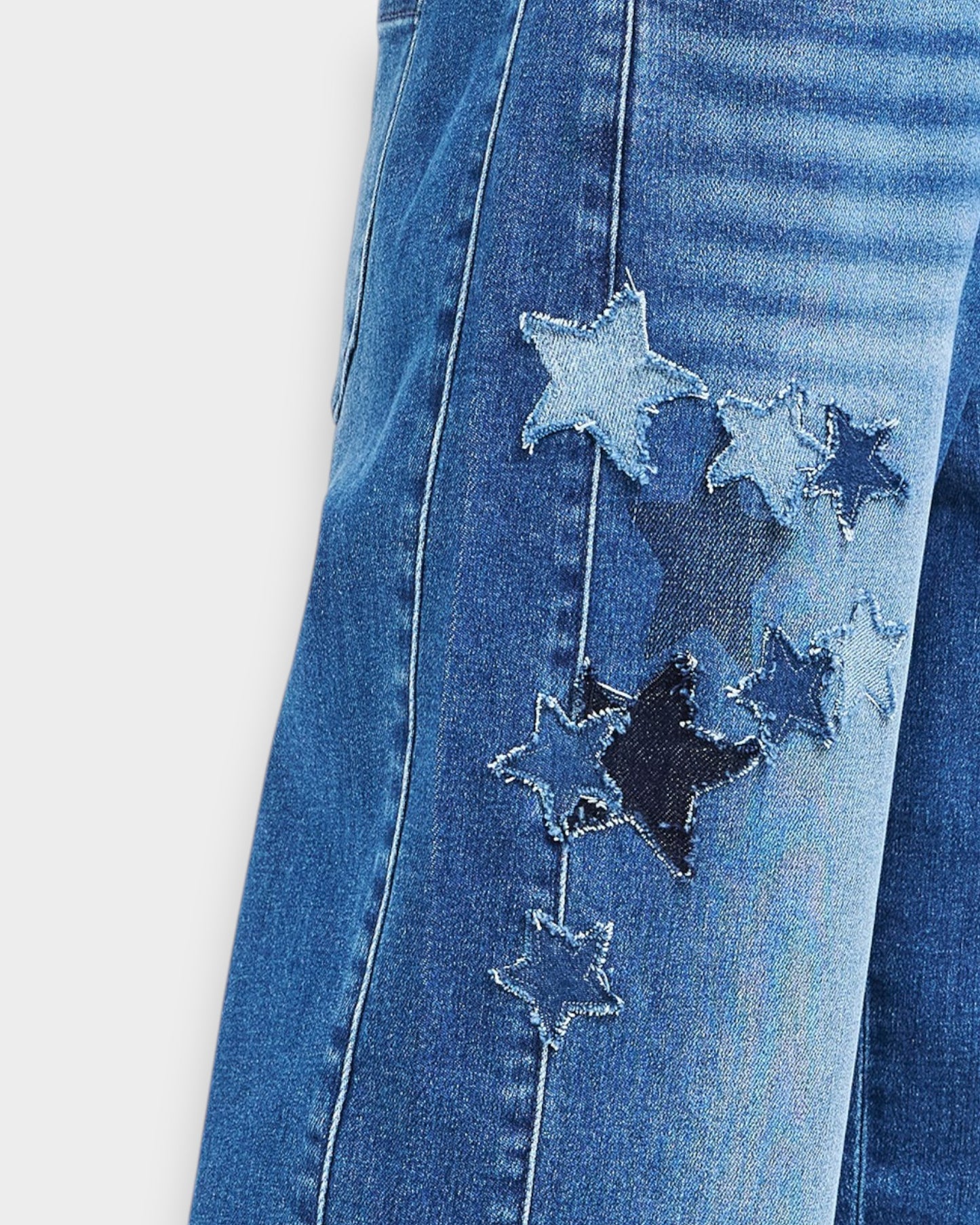 Blue jeans with star-shaped patches on a white background