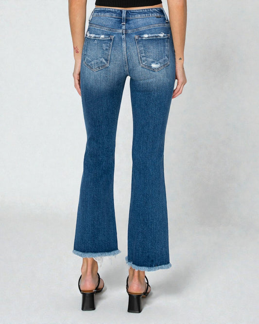 Blue jeans worn by a person on a white background