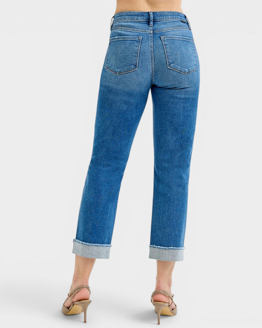 Blue jeans worn by a person on a white background