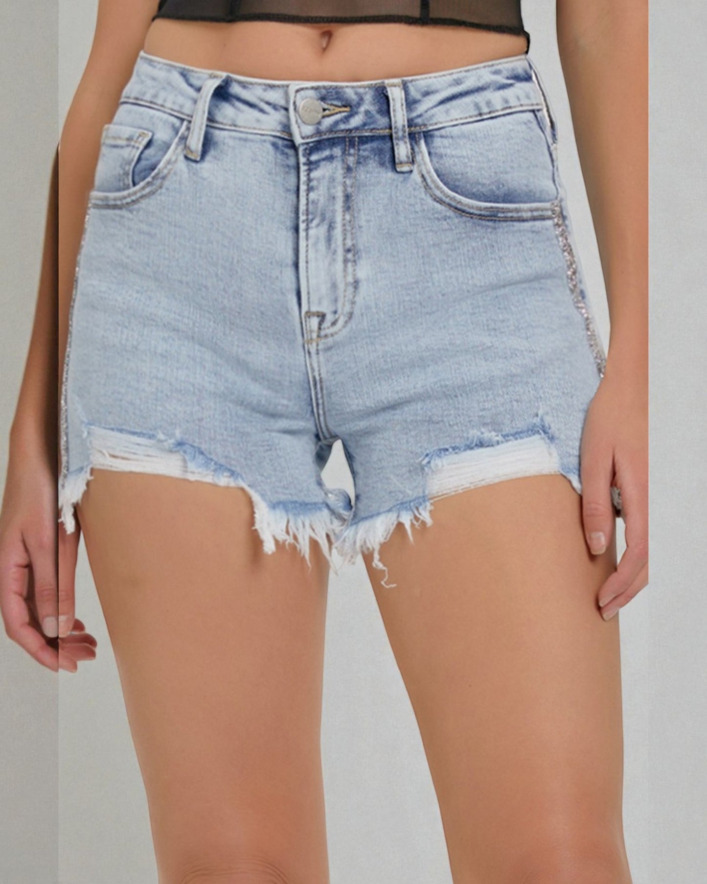 Light blue denim shorts with frayed edges on a neutral background