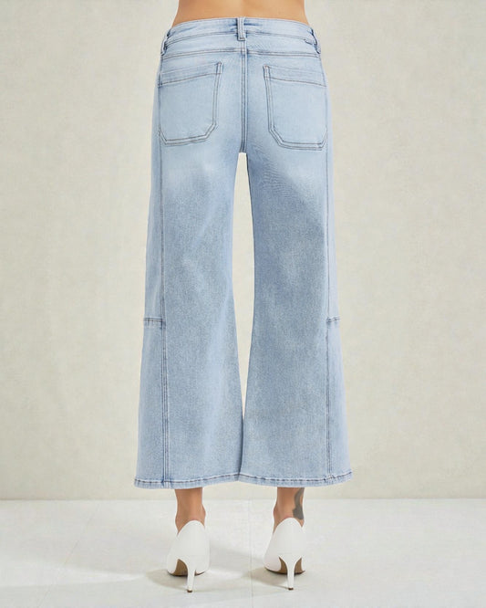 Light blue wide-leg jeans worn by a person on a white background