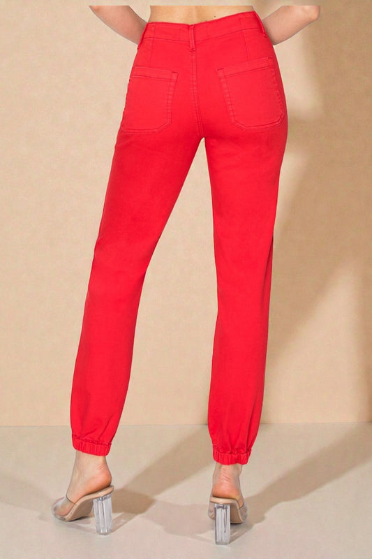 Red pants worn by a person on a beige background