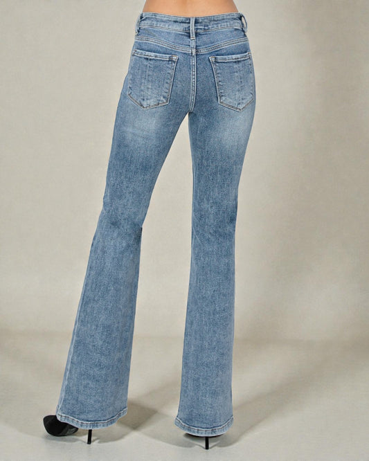 Light blue flared jeans on a neutral background
