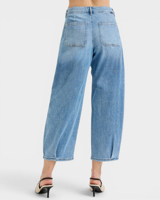 Light blue jeans worn by a person on a white background