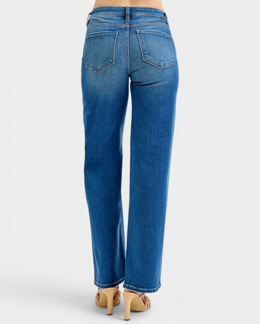 Blue jeans worn by a person on a white background