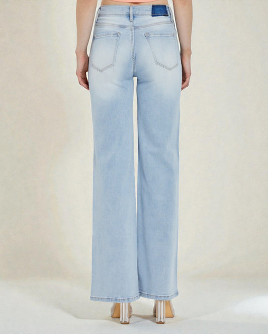 Light blue jeans worn by a person on a plain background