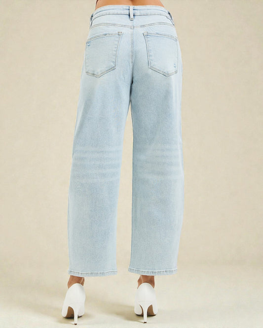 Light blue wide-leg jeans worn by a person on a beige background