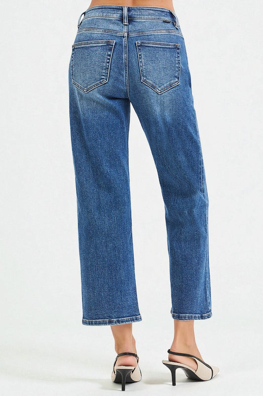 Blue jeans worn by a person on a white background