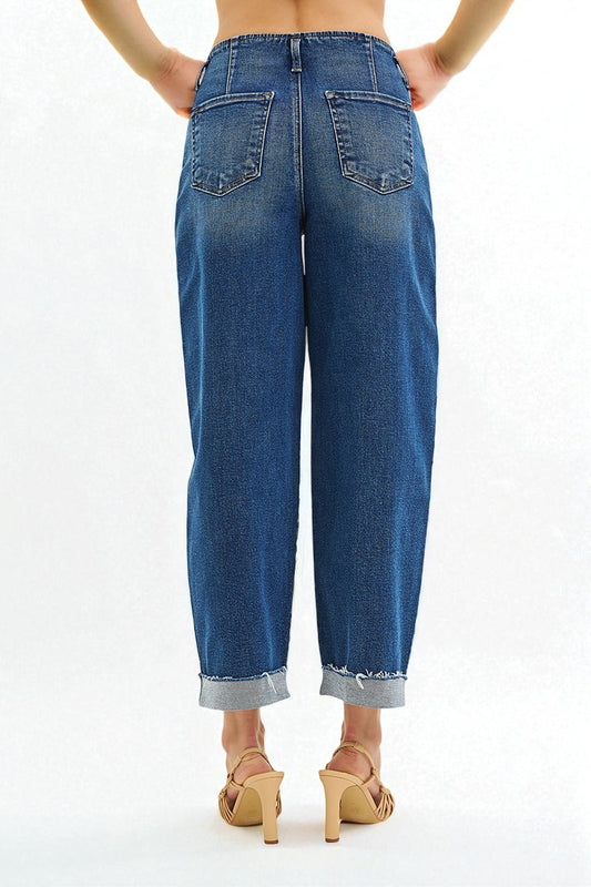 Blue jeans worn by a person on a white background