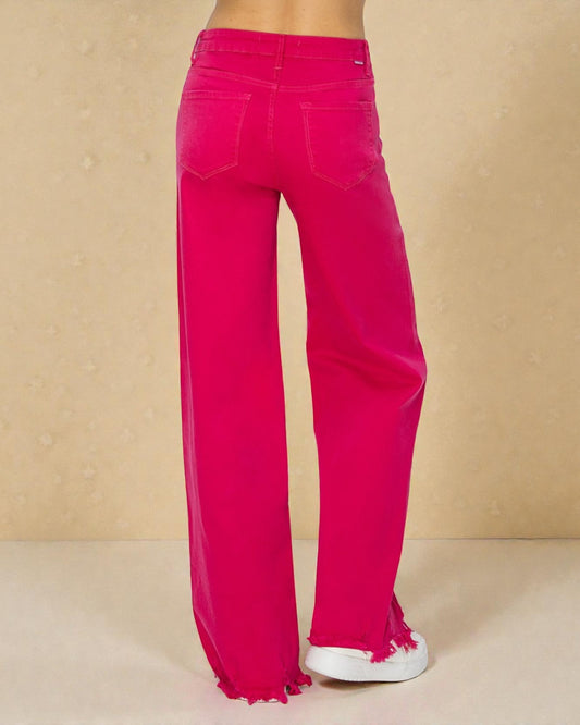 Bright pink wide-leg jeans on a beige background