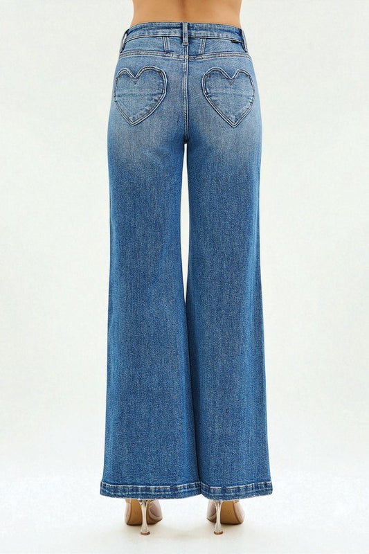 Blue jeans with heart-shaped cutouts on a white background