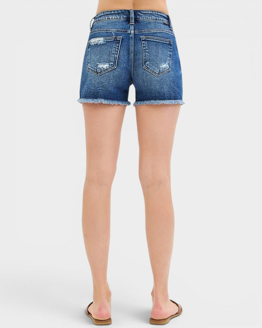 Blue denim shorts worn by a person on a white background