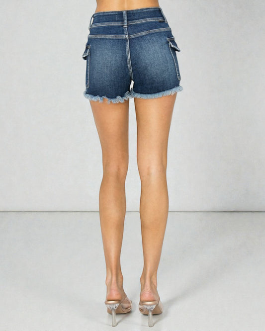 Person wearing blue denim shorts on a plain background