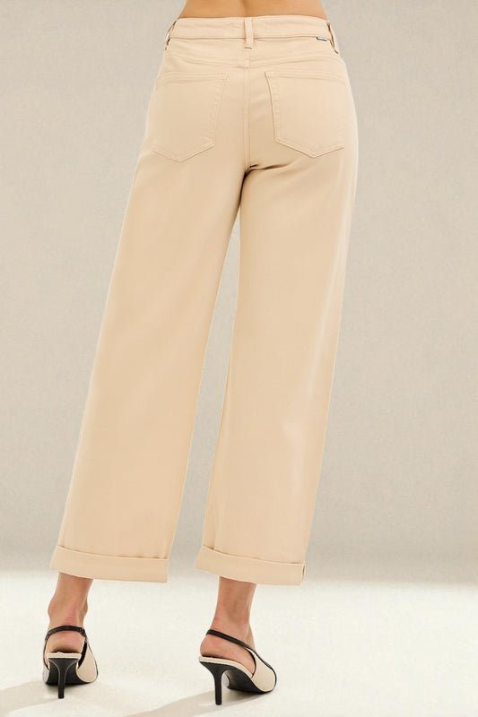 Beige wide-leg pants worn by a person on a neutral background