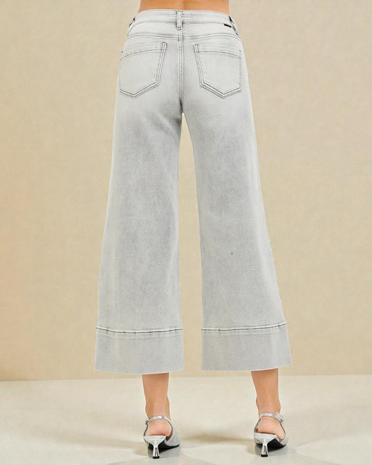 Light gray wide-leg jeans on a beige background