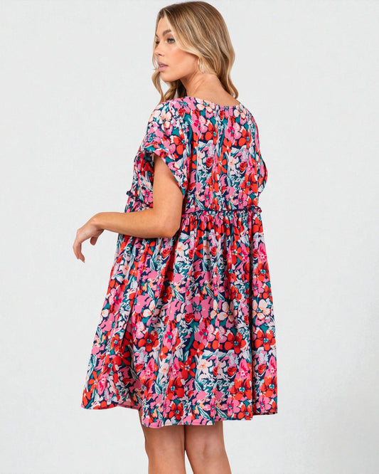 Woman wearing a colorful floral dress on a white background