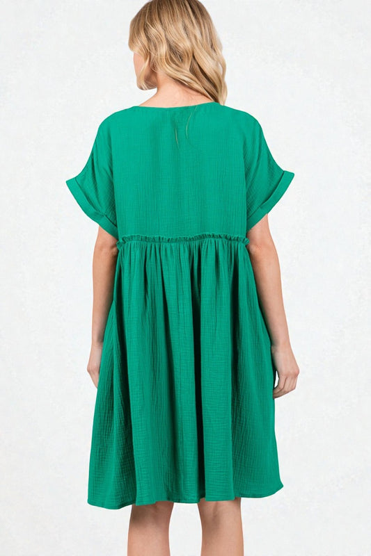 Green dress worn by a model on a white background