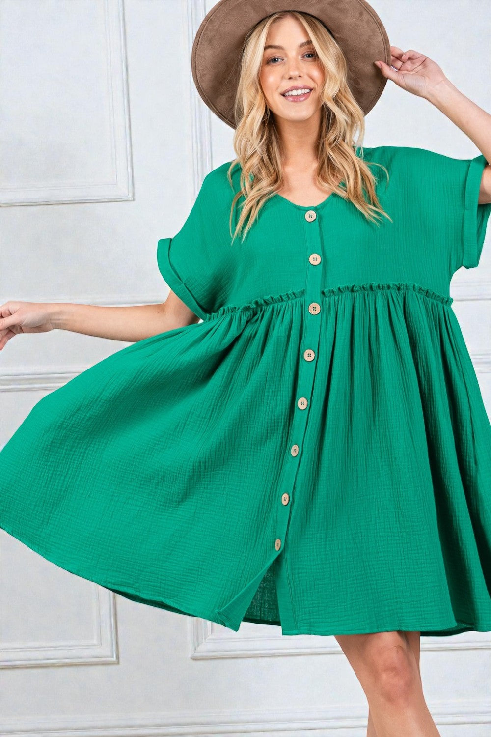 Woman wearing a green dress with a white background