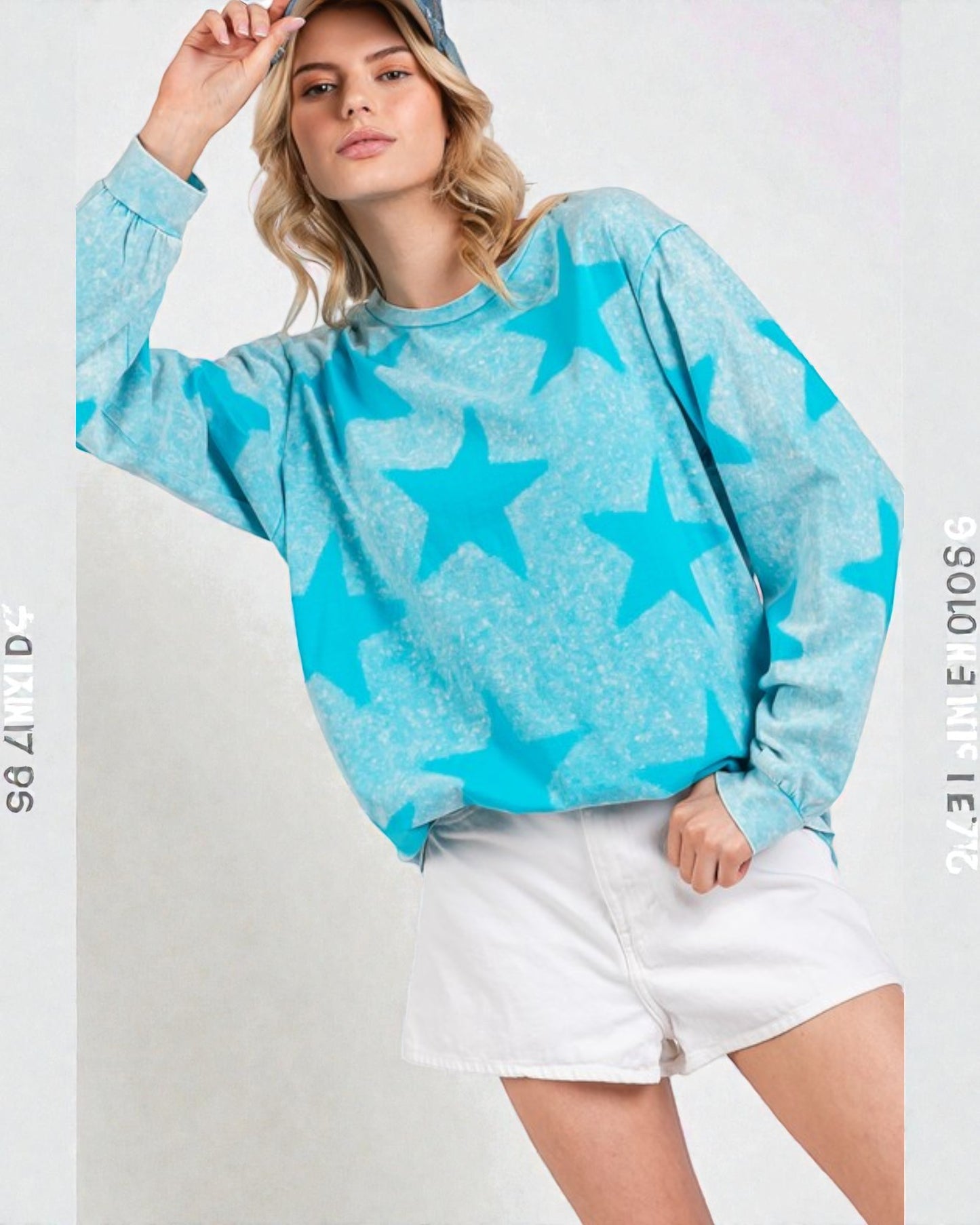 Woman wearing a blue star-patterned sweater and white shorts on a light gray background