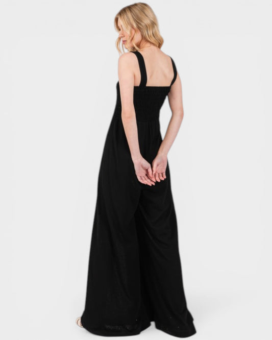 Woman wearing a black sleeveless dress on a white background