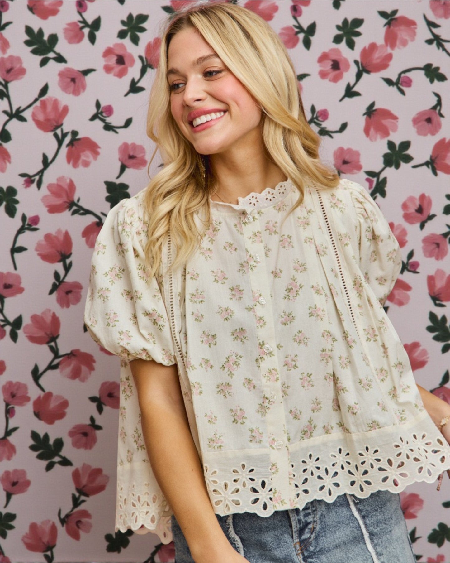 Woman wearing a floral blouse against a floral patterned background