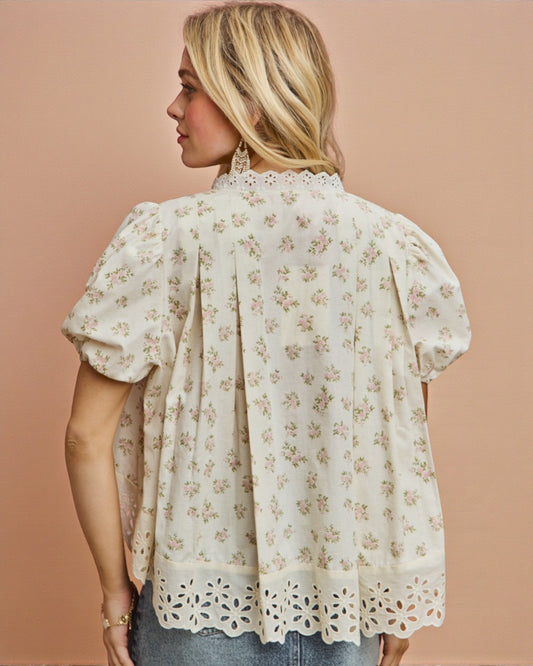 Woman wearing a floral blouse against a beige background