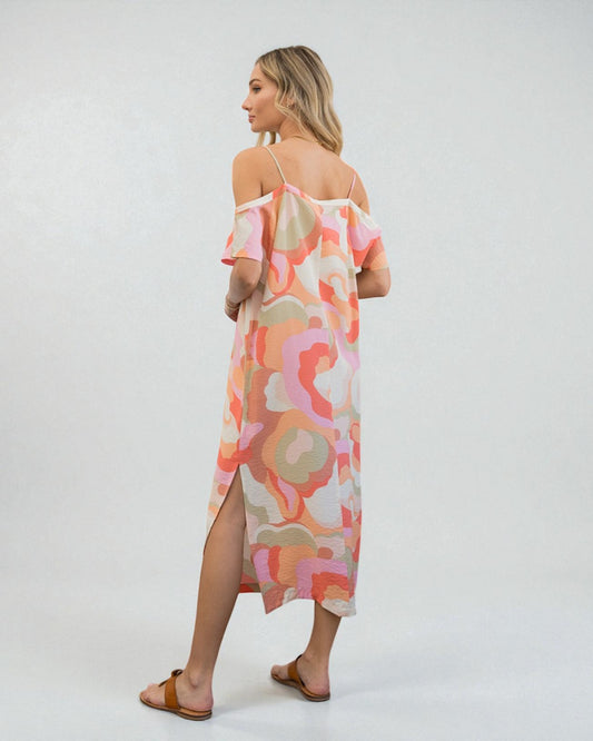 Woman wearing a colorful floral dress on a white background