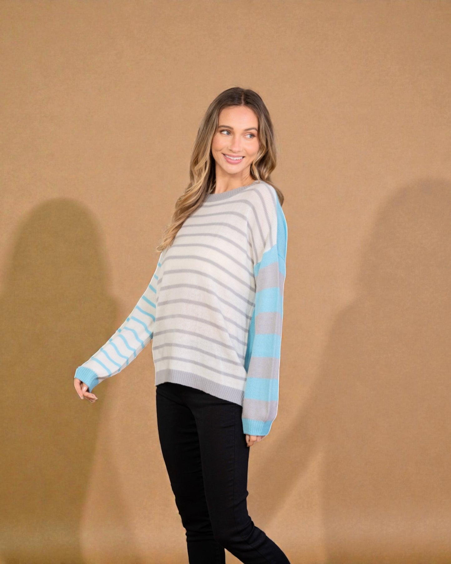 Woman wearing a striped sweater against a brown background