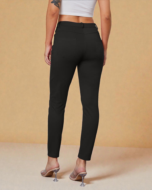 Person wearing black pants on a beige background