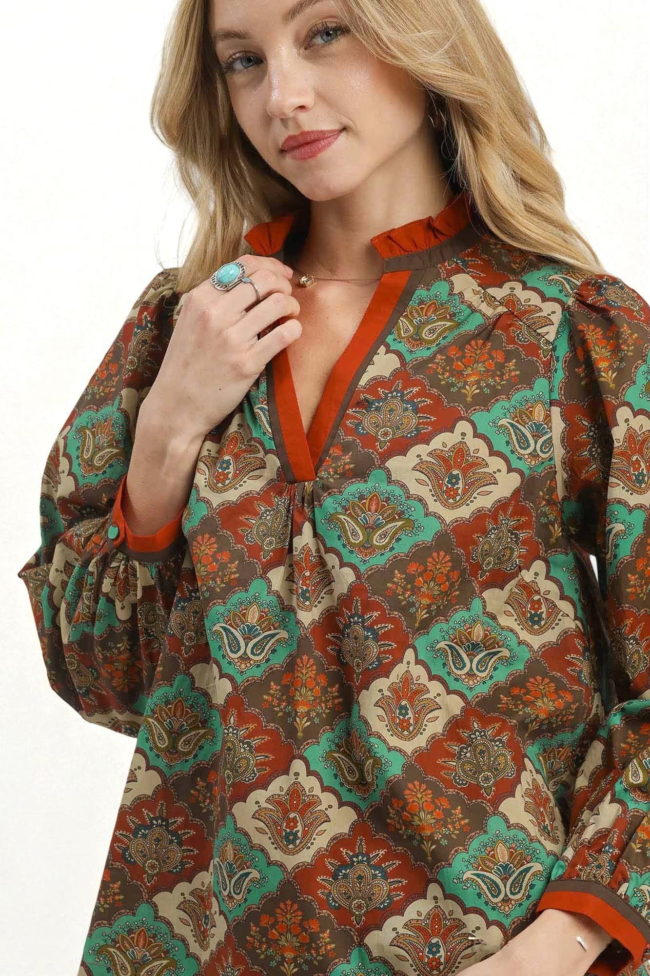 Woman wearing a patterned dress with a white background