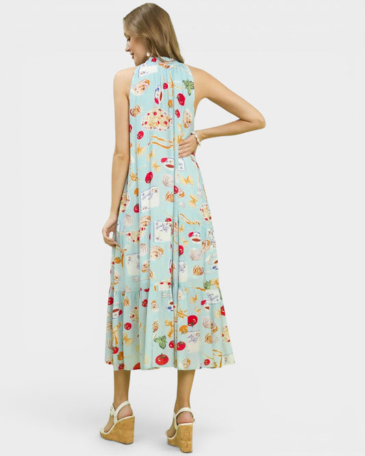Woman wearing a sleeveless dress with a colorful pattern on a white background