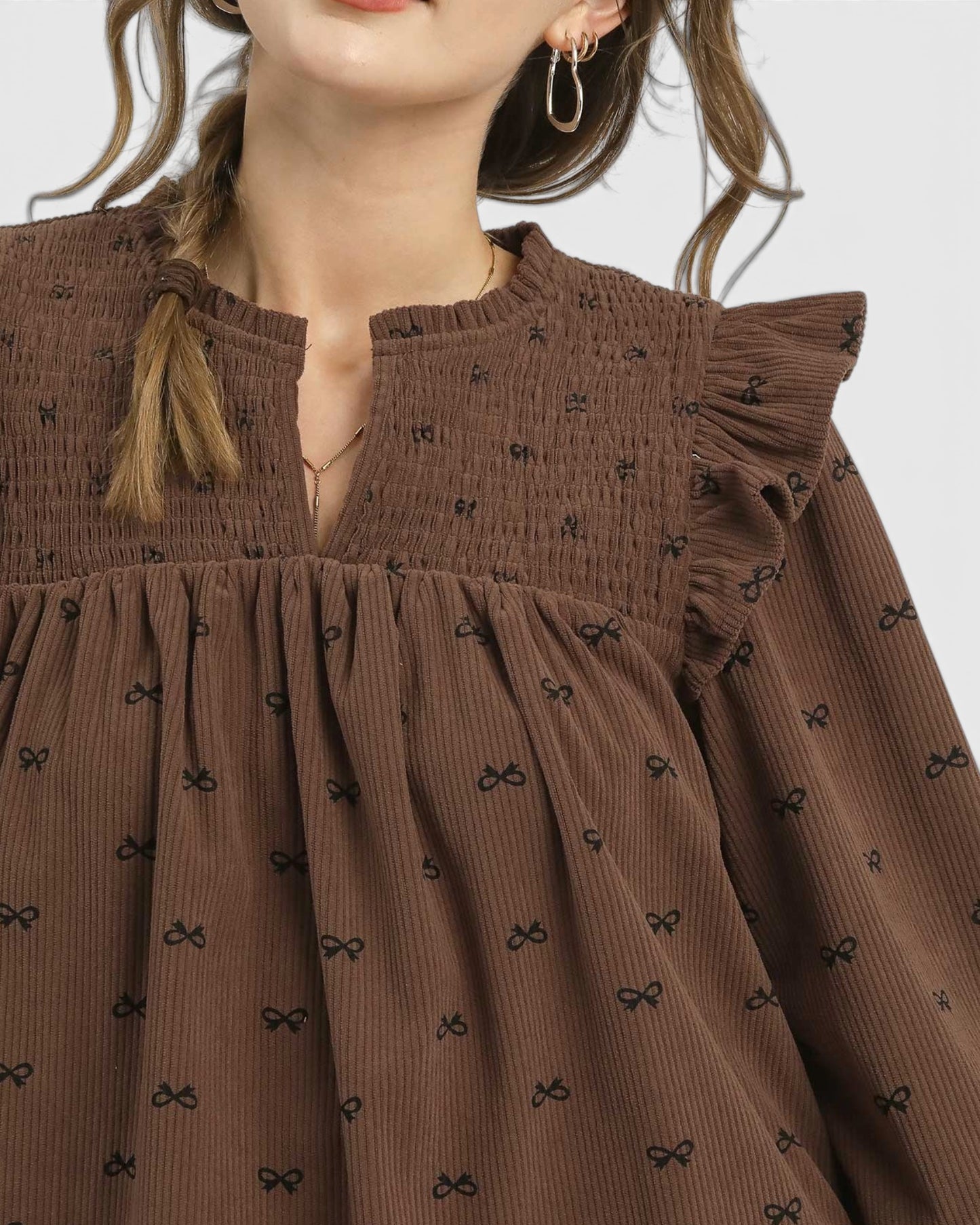Brown dress with black bow pattern worn by a person