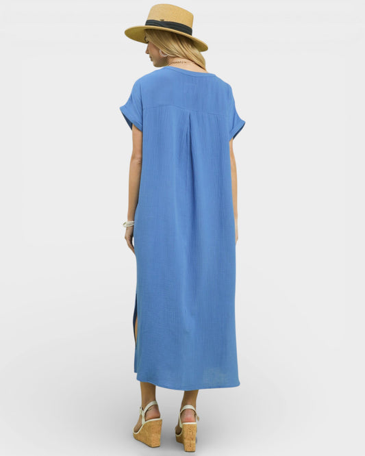 Woman wearing a blue dress with a straw hat on a white background