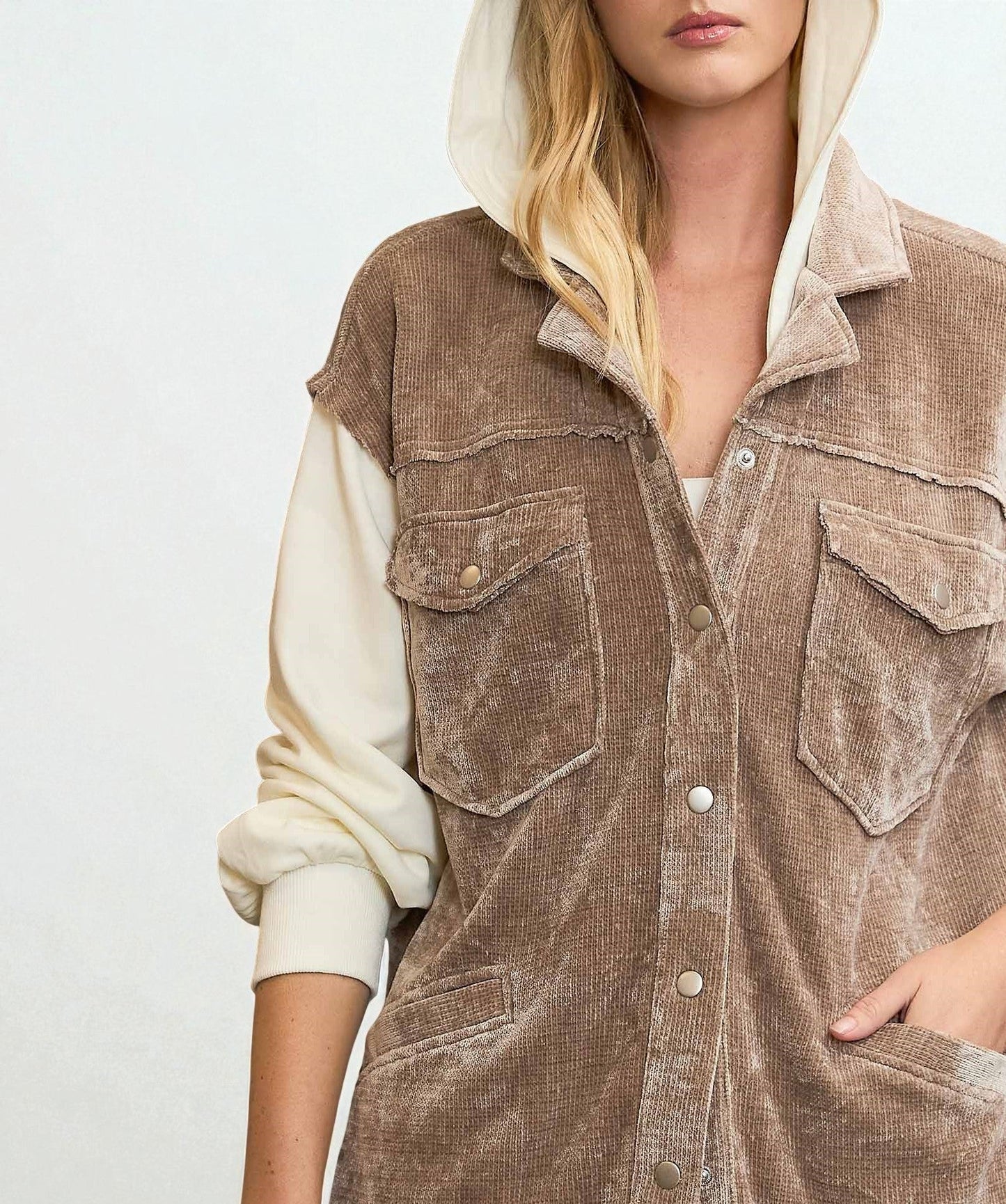 Brown corduroy vest worn by a person on a white background