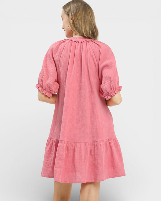 Pink dress with ruffled sleeves on a white background
