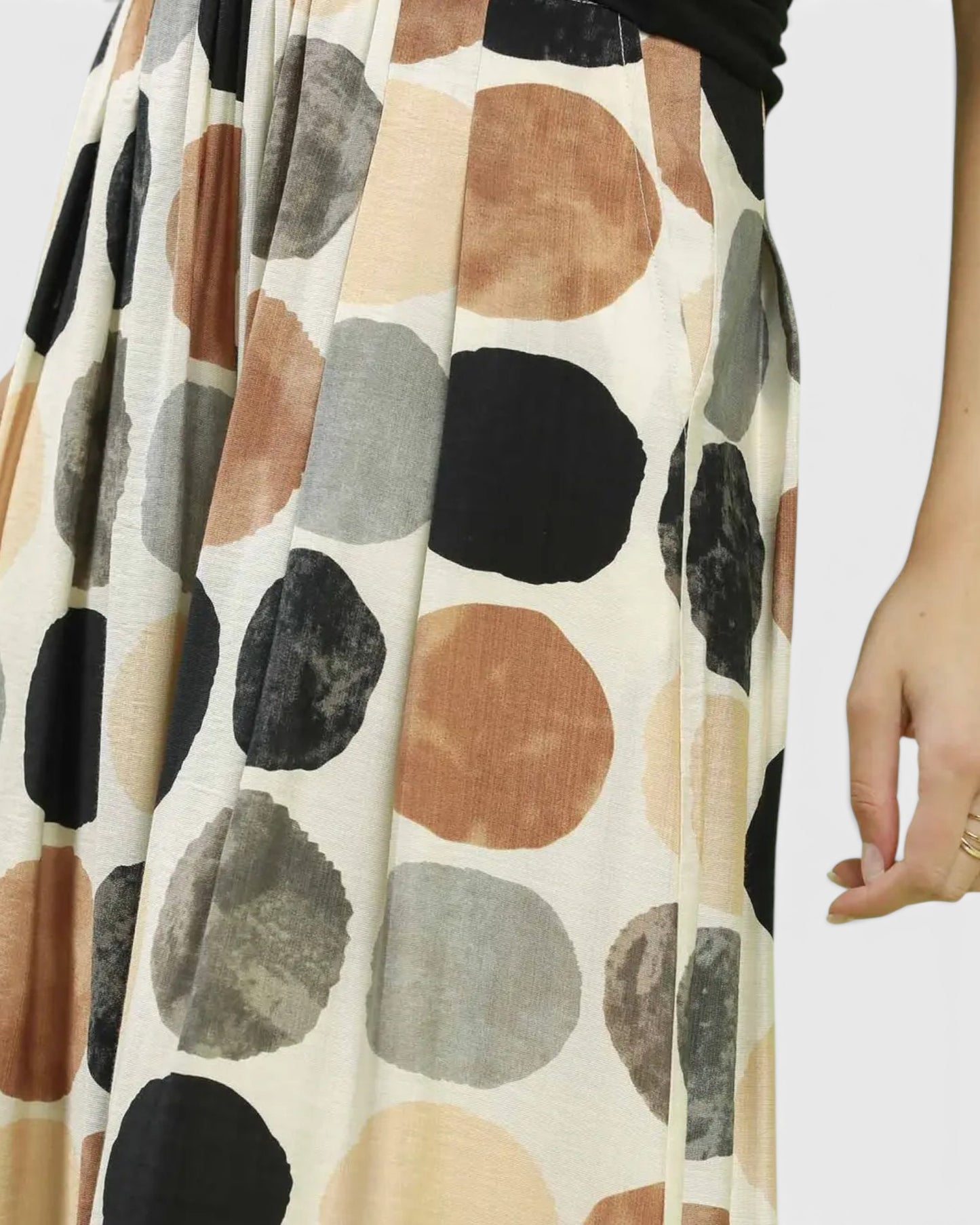 Long skirt with a pattern of large, multicolored circles on a plain background