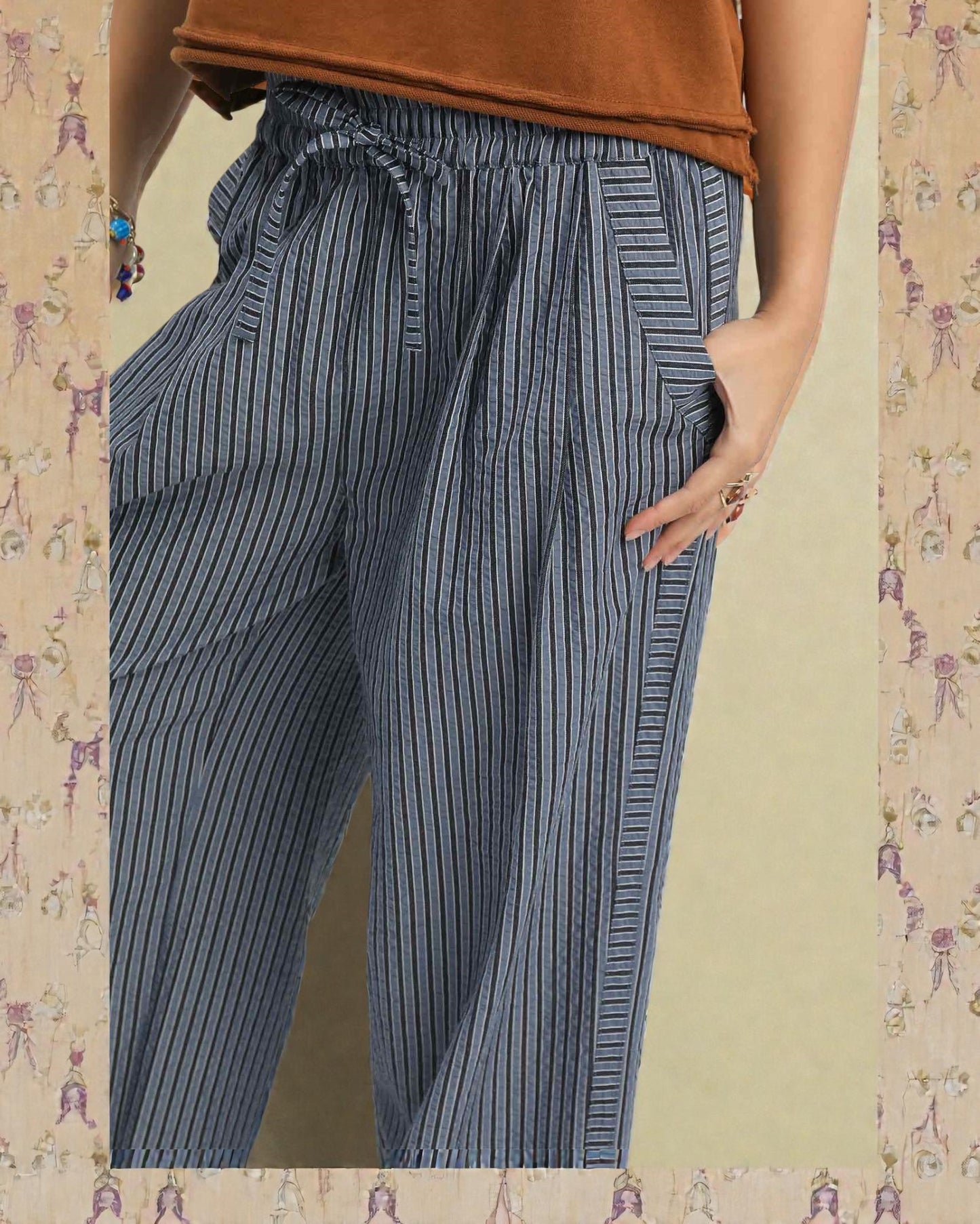 Blue striped pants worn by a person on a patterned background