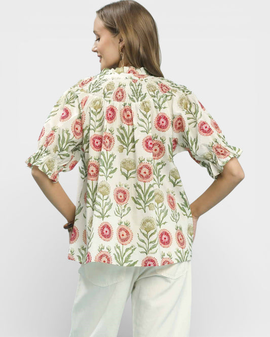 Woman wearing a floral blouse with a white background