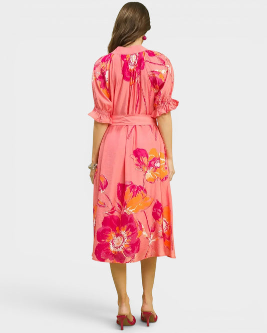 Woman wearing a pink floral dress on a white background